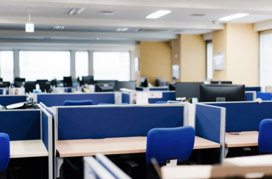 An office full of cubicles is empty of workers