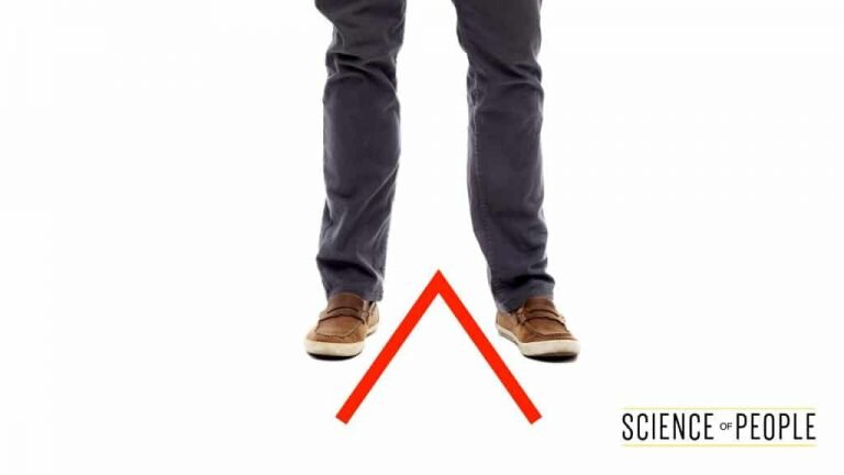 A person stands with their feet in a V-shape pointed towards the camera