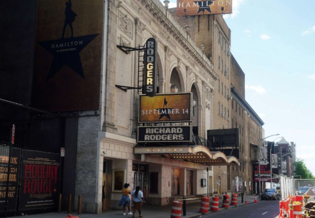 People walk past Broadway show marquees during the COVID-19 pandemic